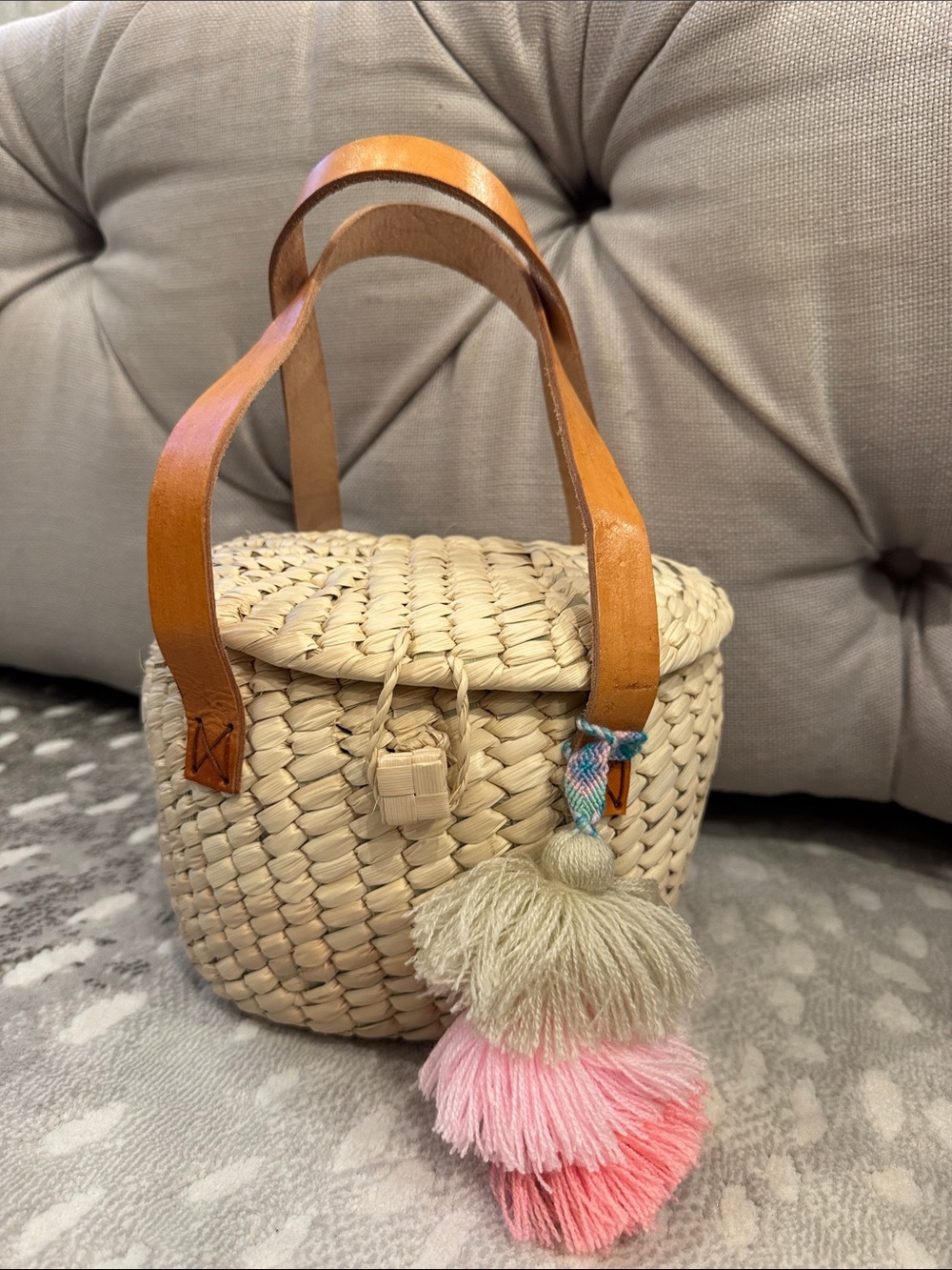 Cream Woven Mini Basket Bag with Tan Leather Handles and Pink Tassel